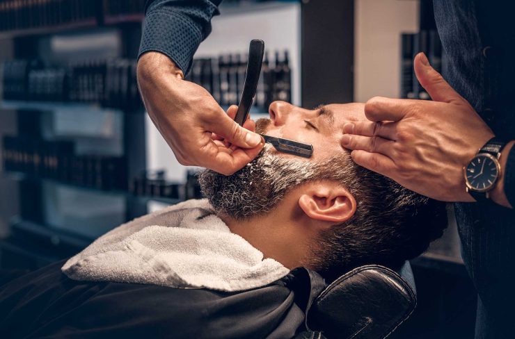 barber-shaving-bearded-male-with-a-sharp-razor-2021-08-28-17-38-11-utc.jpg