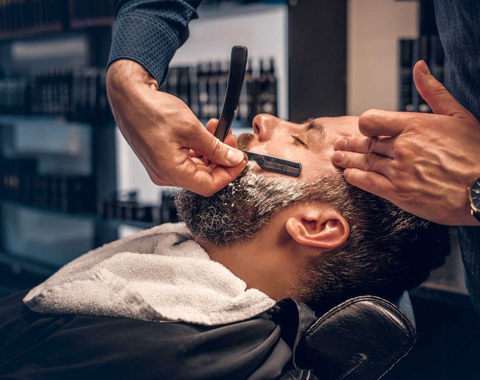 barber-shaving-bearded-male-with-a-sharp-razor-2021-08-28-17-38-11-utc.jpg