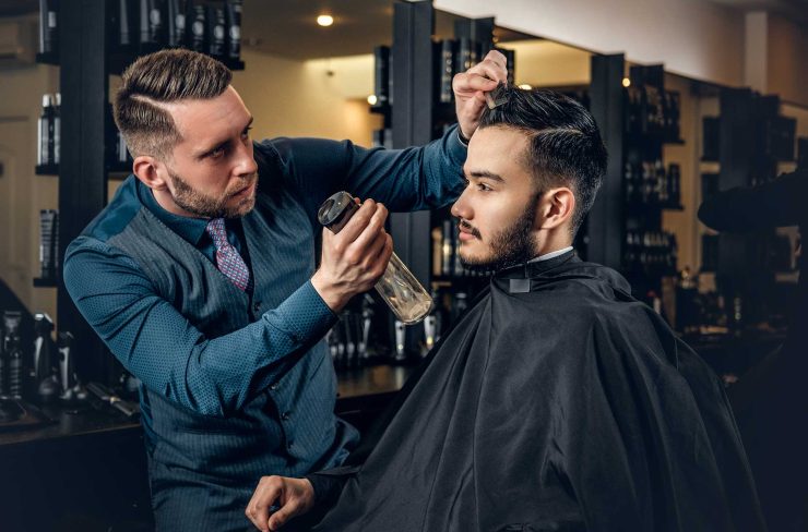 hairdresser-doing-haircut-to-a-bearded-man-in-a-ba-2021-08-28-17-38-11-utc.jpg